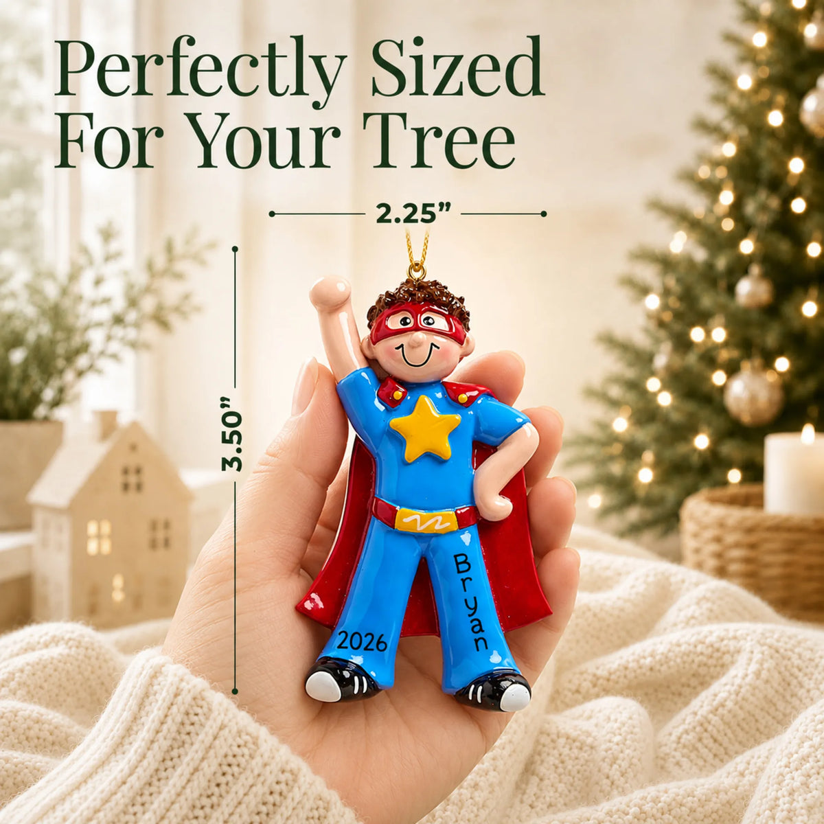 Size guide: the personalized super hero boy christmas ornament is 2.25 in wide by 3.50 in tall, shown in hand