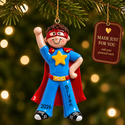 Super hero boy christmas ornament hanging on a lit Christmas tree with a Made Just For You gift tag