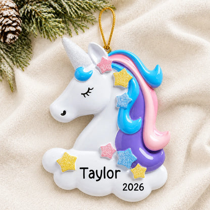 Personalized unicorn christmas ornament laid on a soft white knit blanket