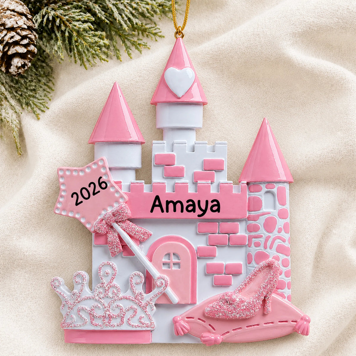 Personalized princess christmas ornament laid on a soft white knit blanket