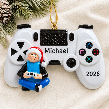 Personalized video game controller christmas ornament laid on a soft white knit blanket