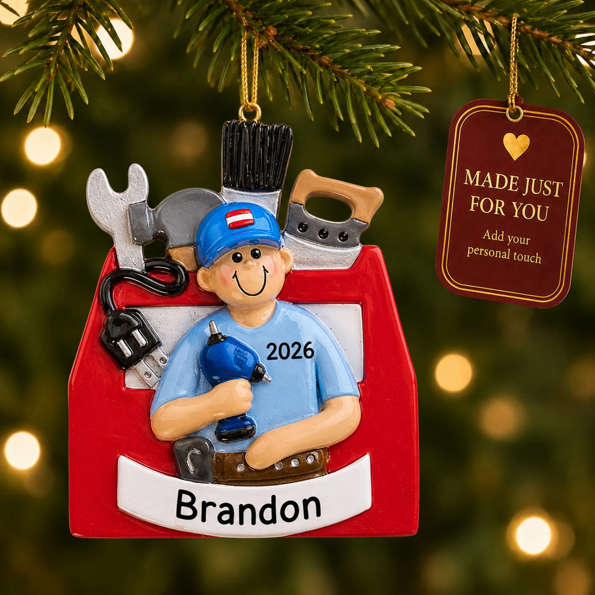 Handyman toolbox christmas ornament hanging on a lit Christmas tree with a Made Just For You gift tag