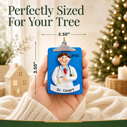 Size guide: the personalized doctor guy clipboard christmas ornament is 2.50 in wide by 3.50 in tall, shown in hand