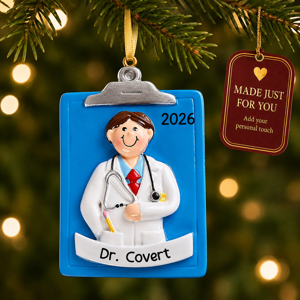 Doctor guy clipboard christmas ornament hanging on a lit Christmas tree with a Made Just For You gift tag