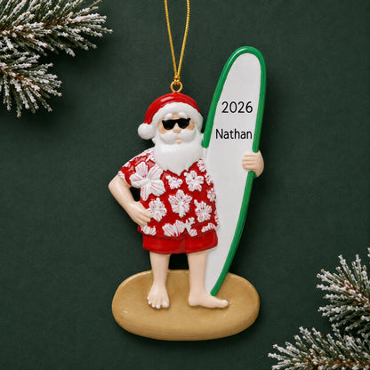 Personalized Santa surfboard christmas ornament on a dark green pine background