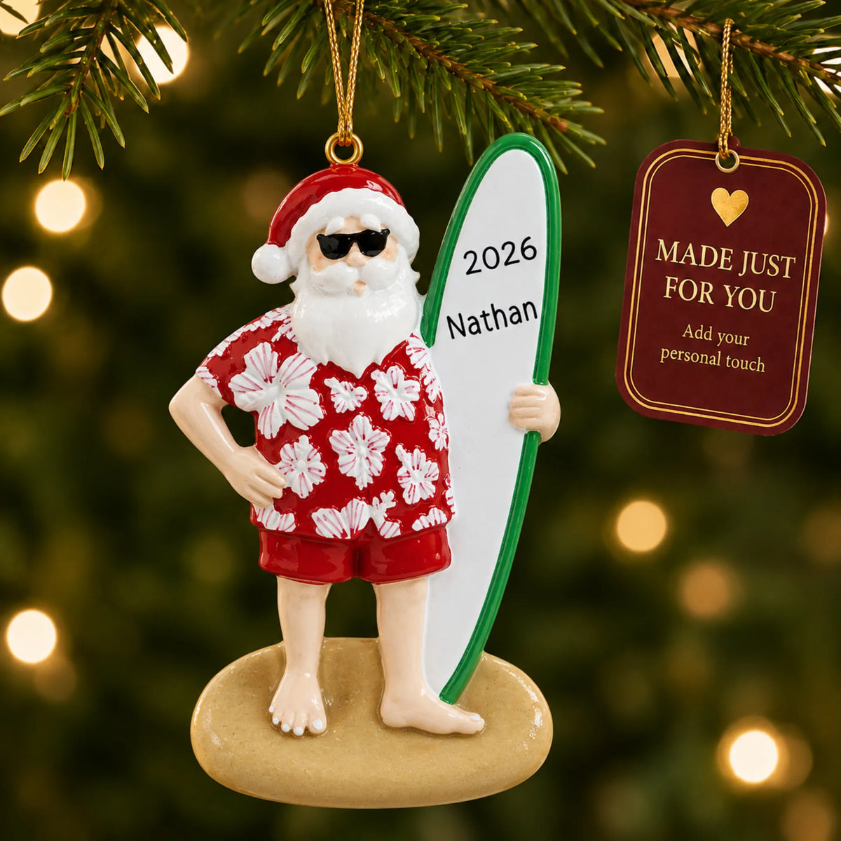 Santa surfboard christmas ornament hanging on a lit Christmas tree with a Made Just For You gift tag