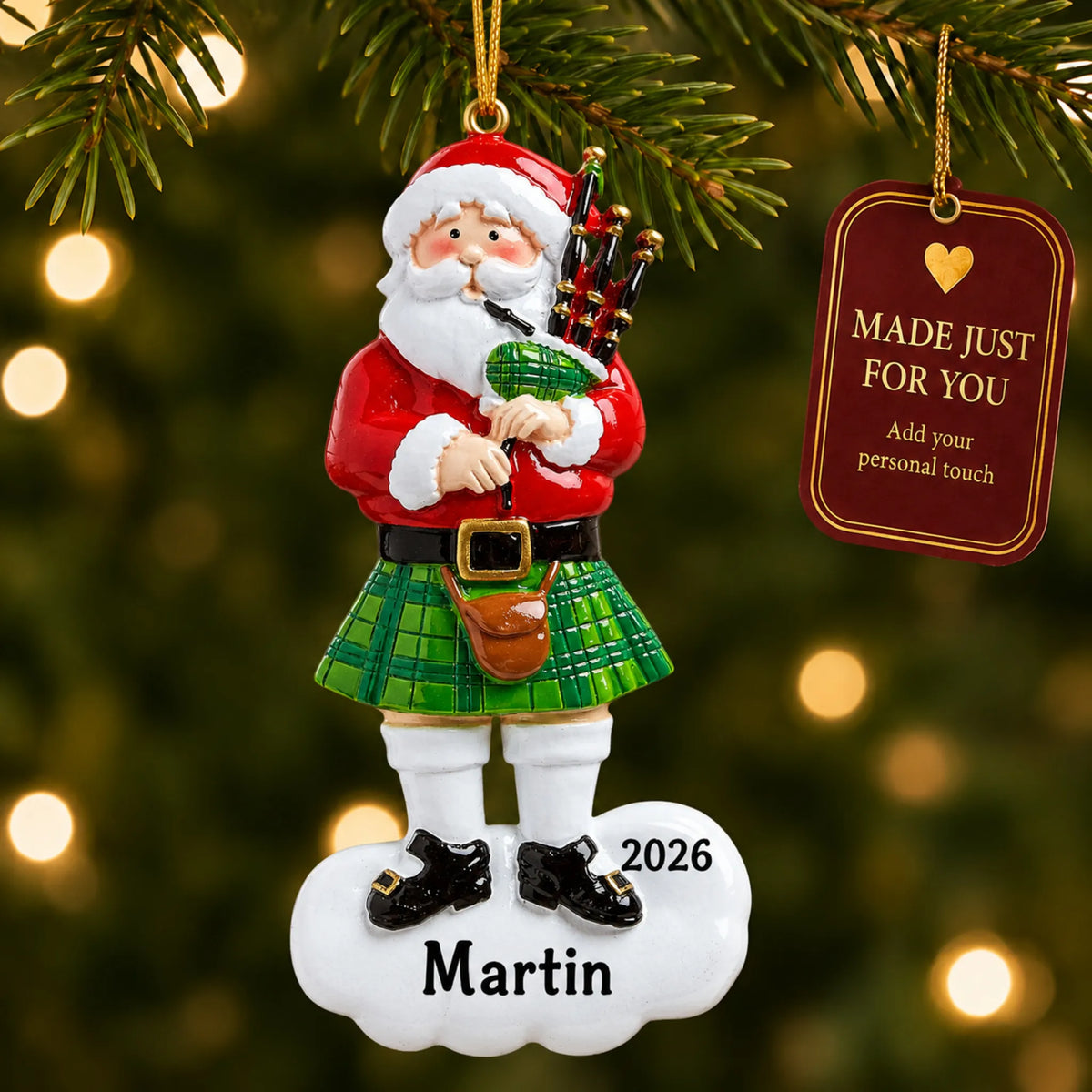 Scottish Bagpipes Santa christmas ornament hanging on a lit Christmas tree with a Made Just For You gift tag