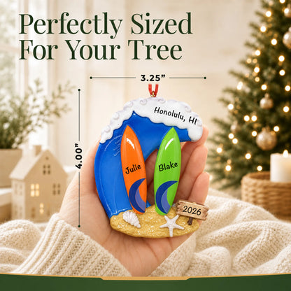 Size guide: the personalized big wave surfing couple christmas ornament is 3.25 in wide by 4.00 in tall, shown in hand
