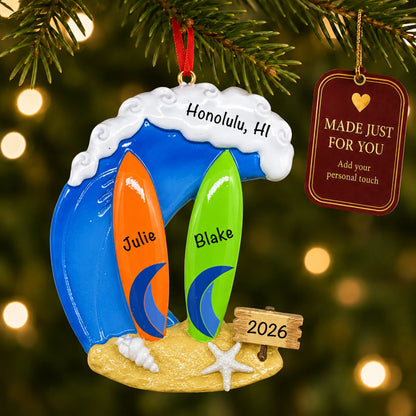 Big wave surfing couple christmas ornament hanging on a lit Christmas tree with a Made Just For You gift tag