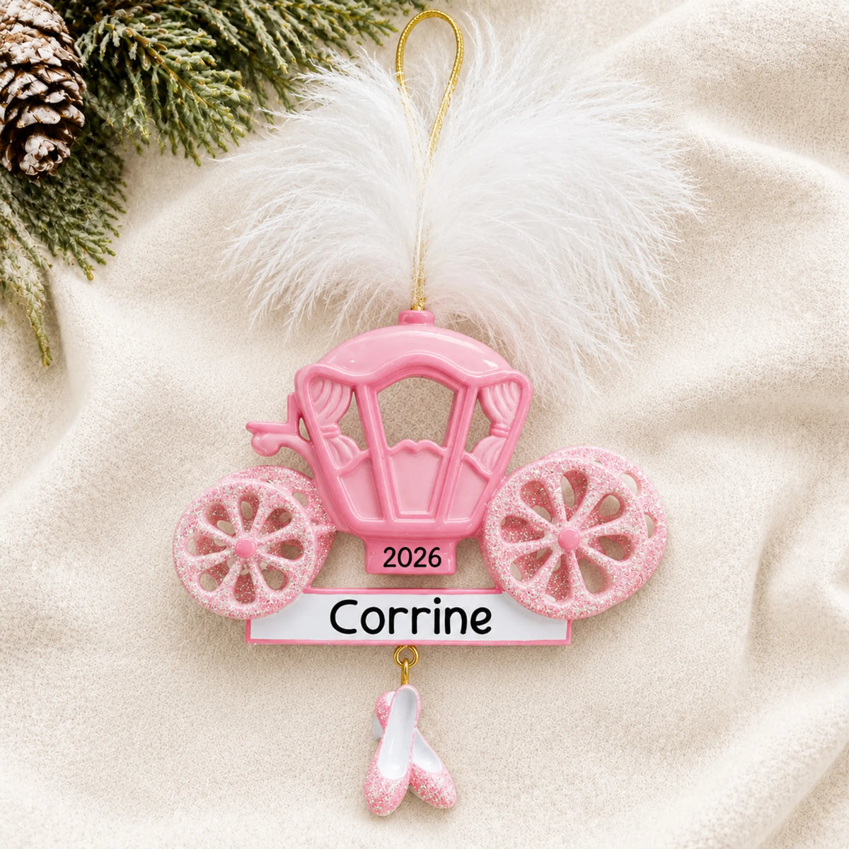 Personalized princess carriage christmas ornament laid on a soft white knit blanket