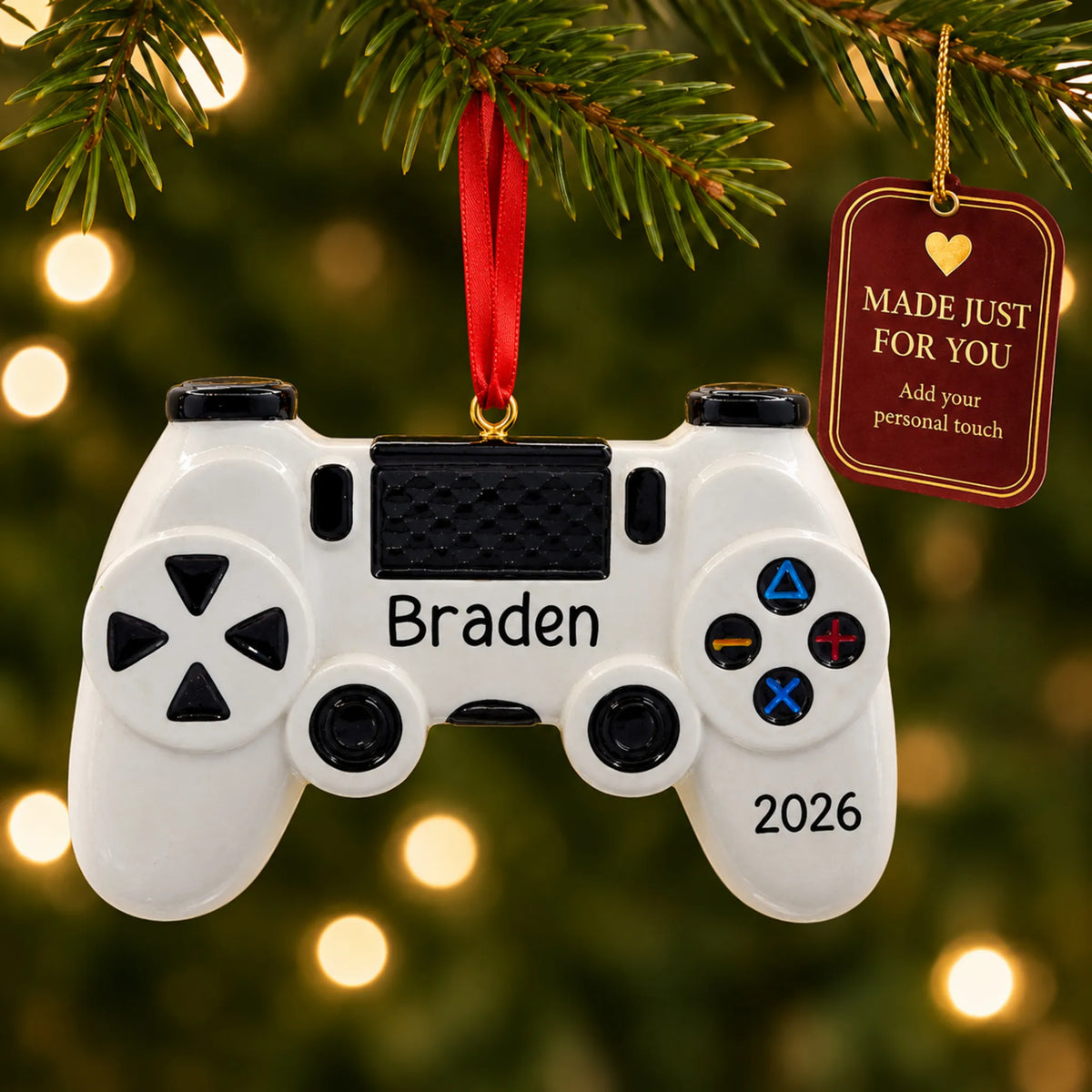 Gaming controller christmas ornament hanging on a lit Christmas tree with a Made Just For You gift tag