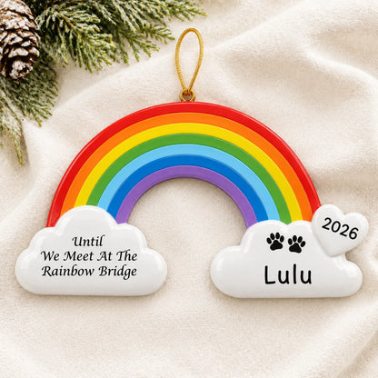Personalized Pet Rainbow Bridge Memorial christmas ornament laid on a soft white knit blanket