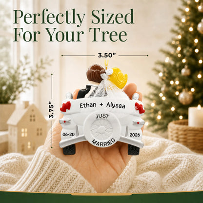 Personalized blonde Just Married wedding car Christmas ornament held in a hand to show its 3.5 by 3.75 inch size