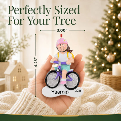 Size guide: the personalized brunette girl bike christmas ornament is 3.00 in wide by 4.25 in tall, shown in hand