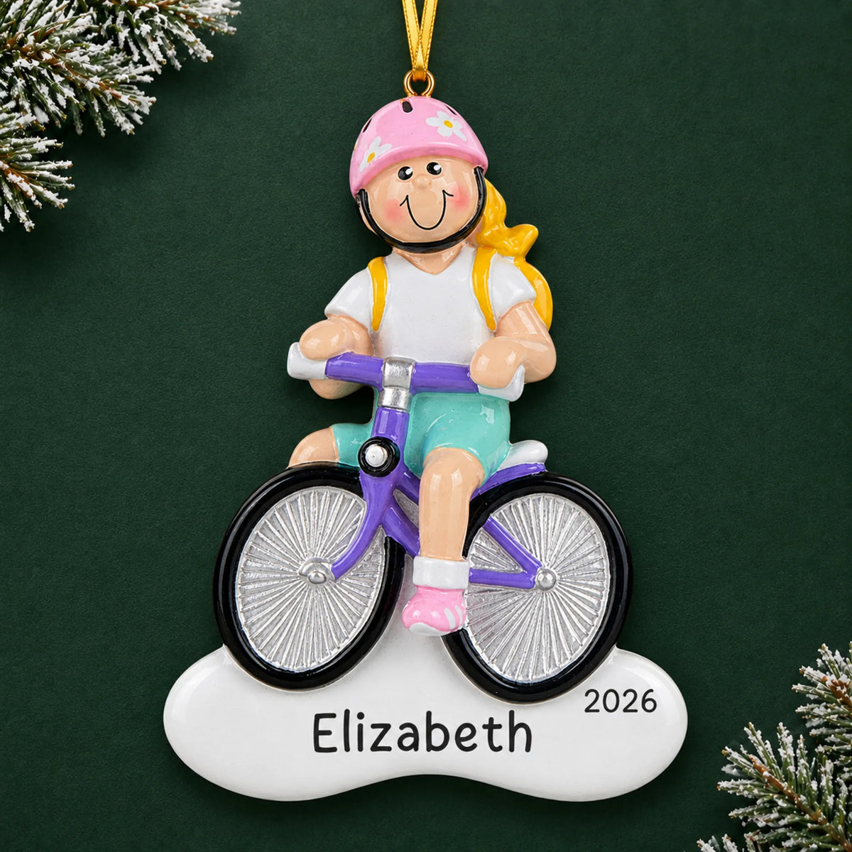 Personalized blonde girl bike christmas ornament on a dark green pine background
