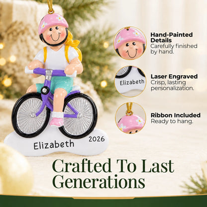 Hand-painted details and laser engraved personalization on the blonde girl bike christmas ornament, ribbon included