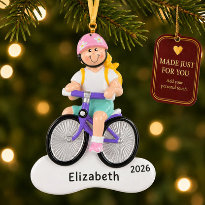 Blonde girl bike christmas ornament hanging on a lit Christmas tree with a Made Just For You gift tag