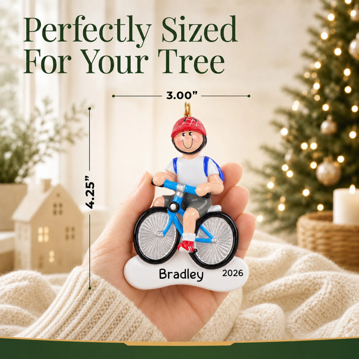 Size guide: the personalized boy riding a bike christmas ornament is 3.00 in wide by 4.25 in tall, shown in hand