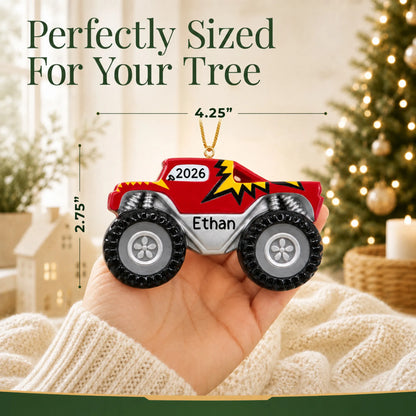 Size guide: the personalized monster truck big wheels christmas ornament shown in hand next to a Christmas tree
