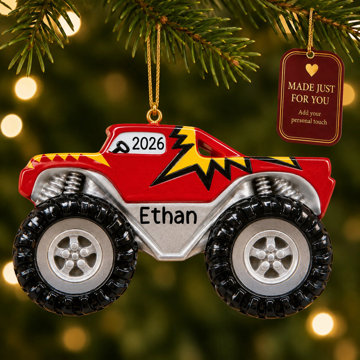 Monster truck big wheels christmas ornament hanging on a lit Christmas tree with a Made Just For You gift tag