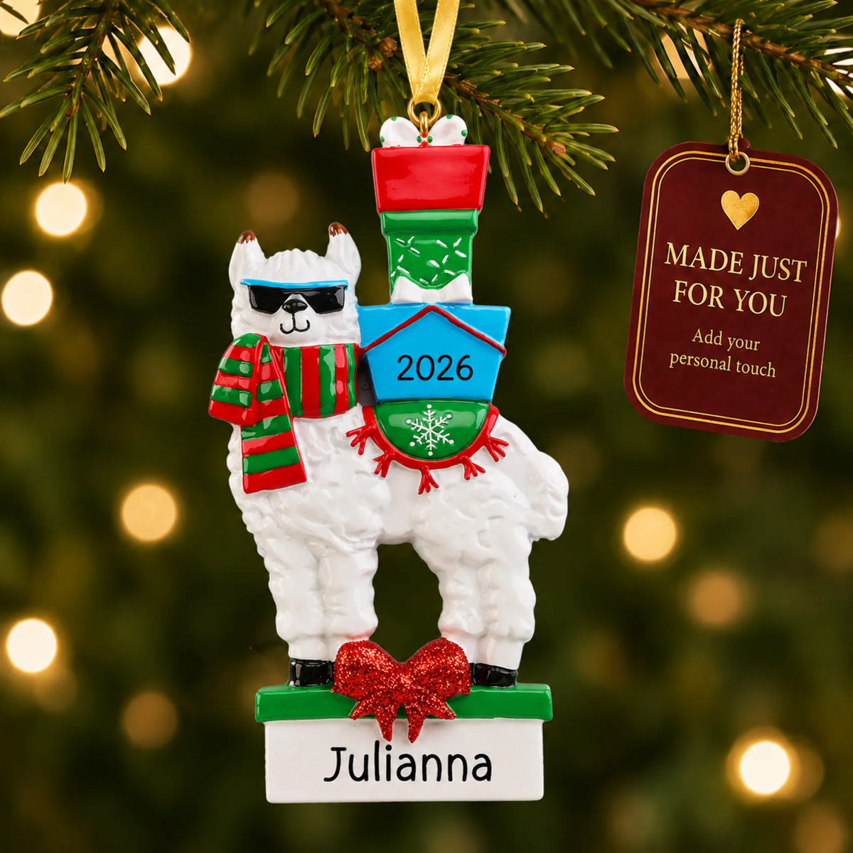 Llama christmas ornament hanging on a lit Christmas tree with a Made Just For You gift tag