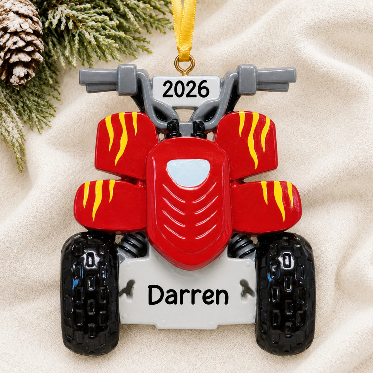 Personalized ATV quad christmas ornament laid on a soft white knit blanket
