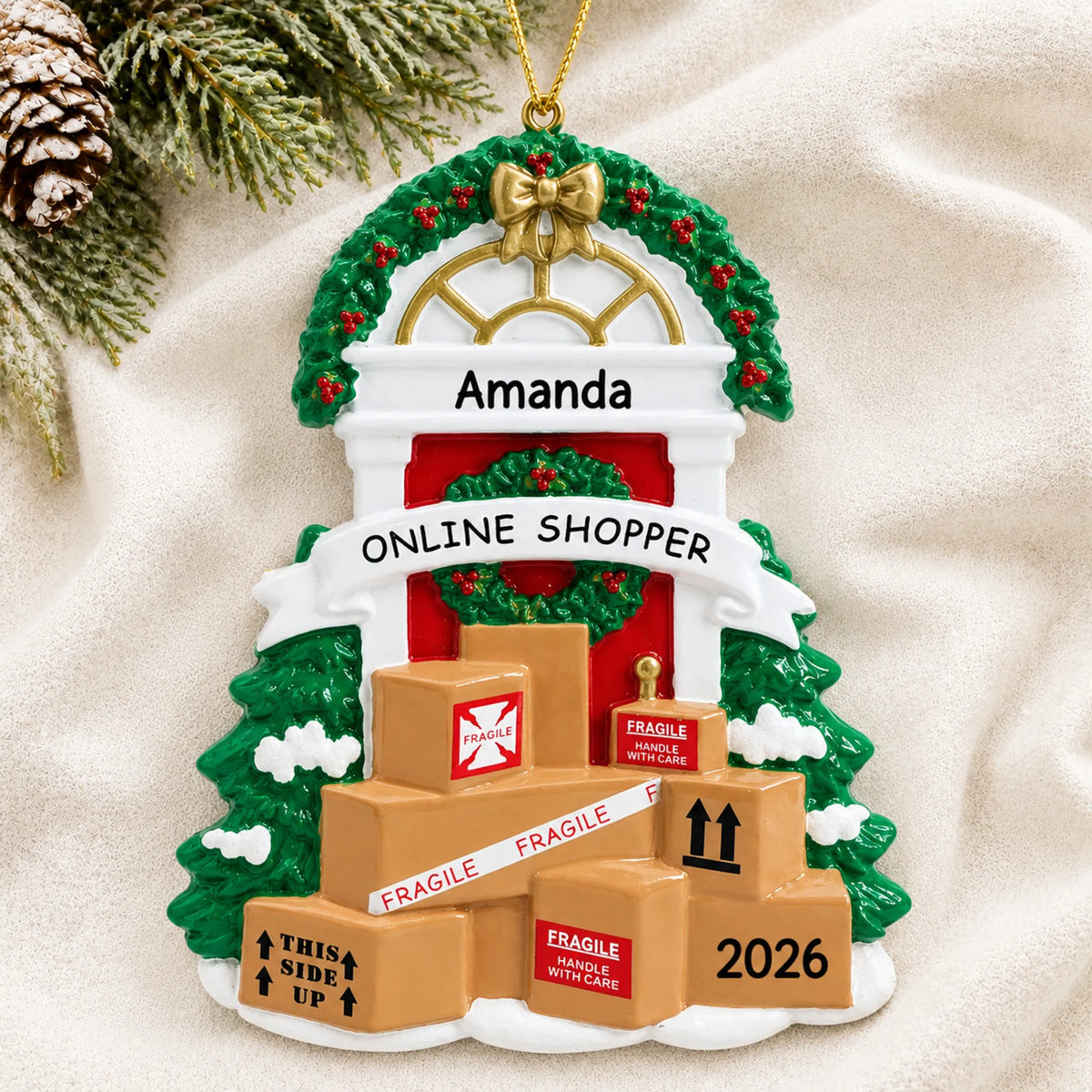 Personalized online shopper christmas ornament laid on a soft white knit blanket