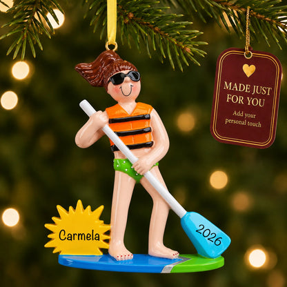 Paddle board girl christmas ornament hanging on a lit Christmas tree with a Made Just For You gift tag