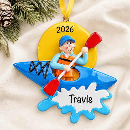 Personalized kayak guy christmas ornament laid on a soft white knit blanket