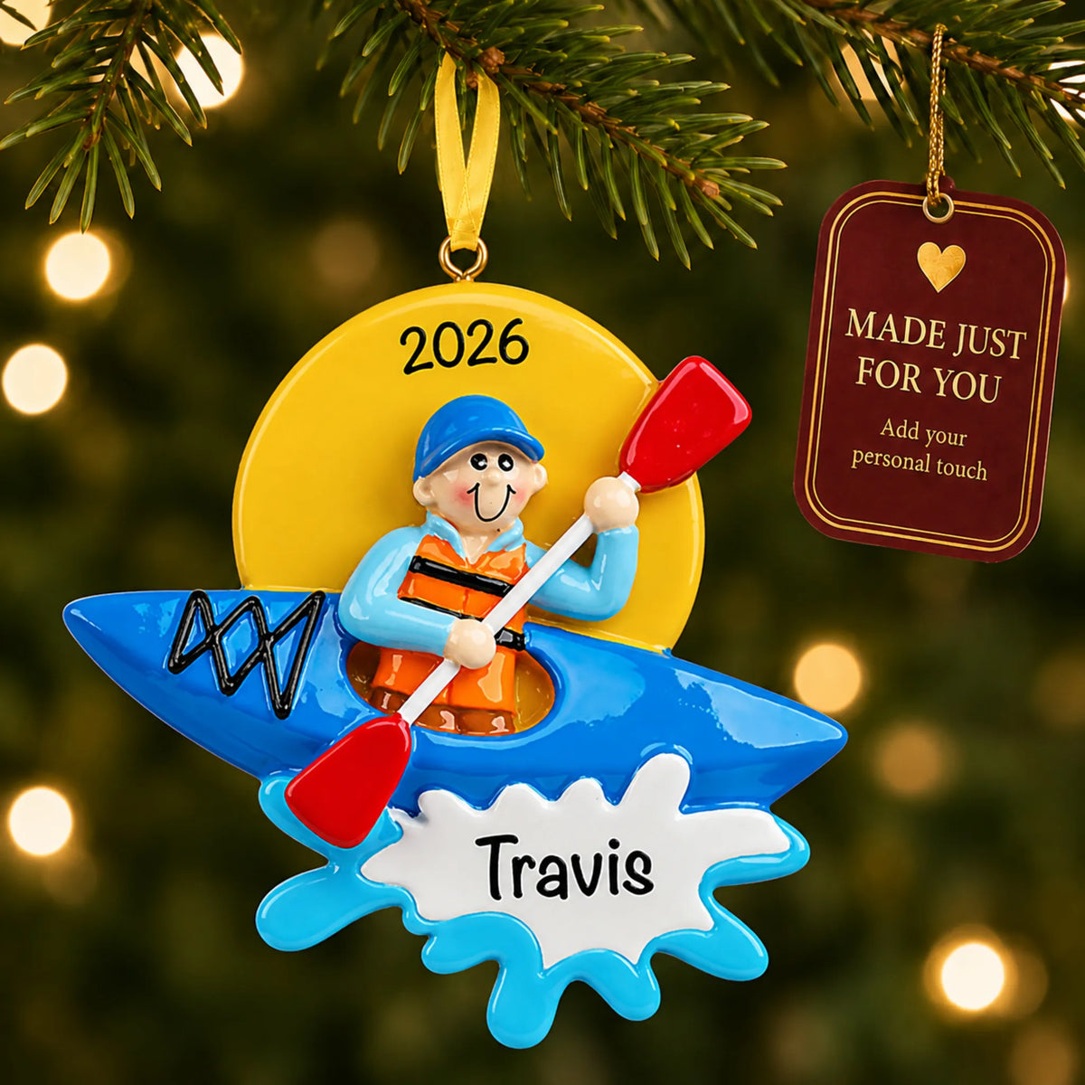Kayak guy christmas ornament hanging on a lit Christmas tree with a Made Just For You gift tag