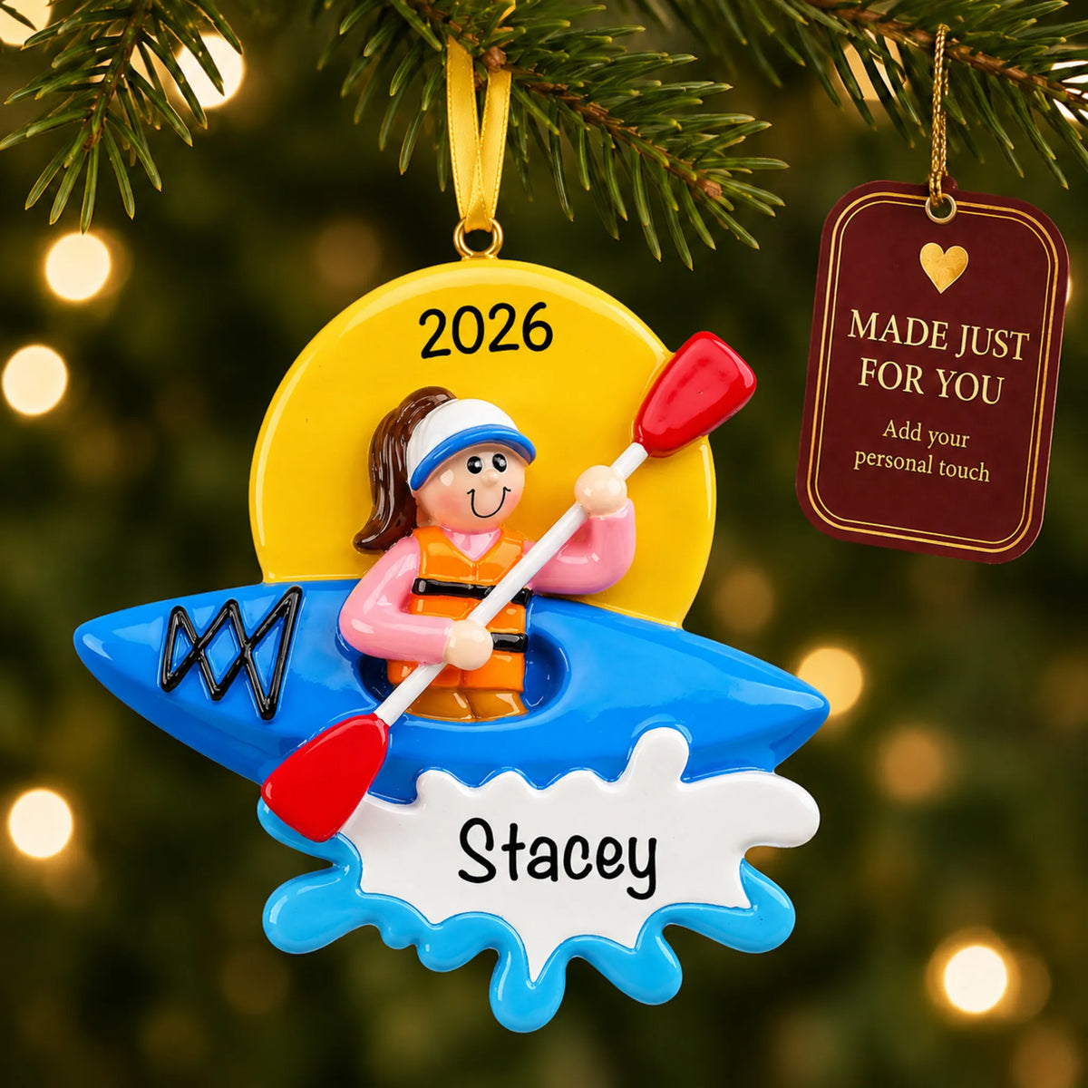 Kayak girl christmas ornament hanging on a lit Christmas tree with a Made Just For You gift tag