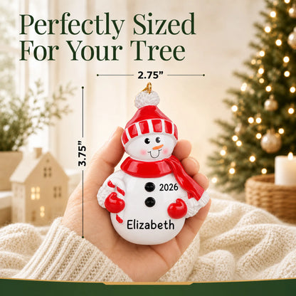 Size guide: the personalized Snowman Red Hat christmas ornament is 2.75 in wide by 3.75 in tall, shown in hand