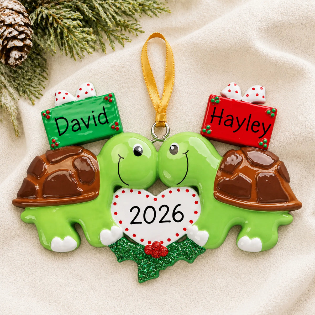 Personalized turtle love couple christmas ornament laid on a soft white knit blanket