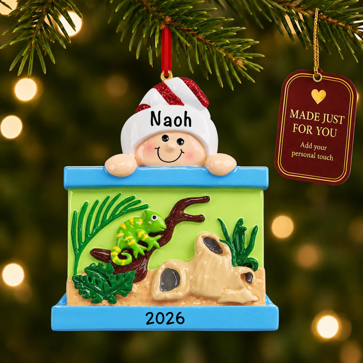 Reptile Lover christmas ornament hanging on a lit Christmas tree with a Made Just For You gift tag