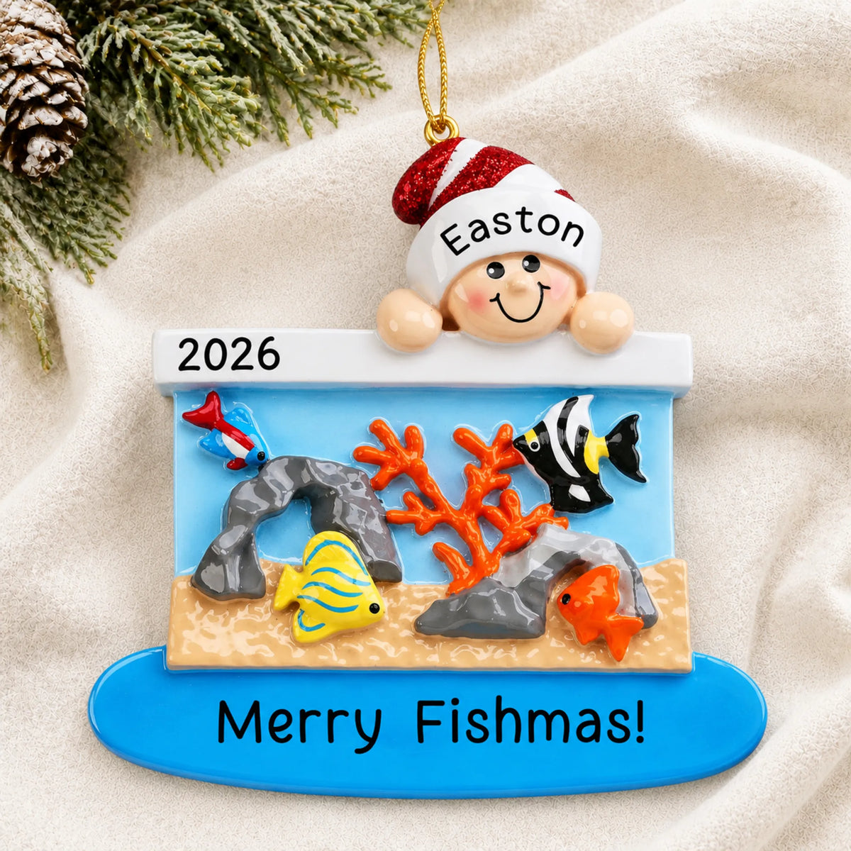 Personalized Fish Aquarium christmas ornament laid on a soft white knit blanket