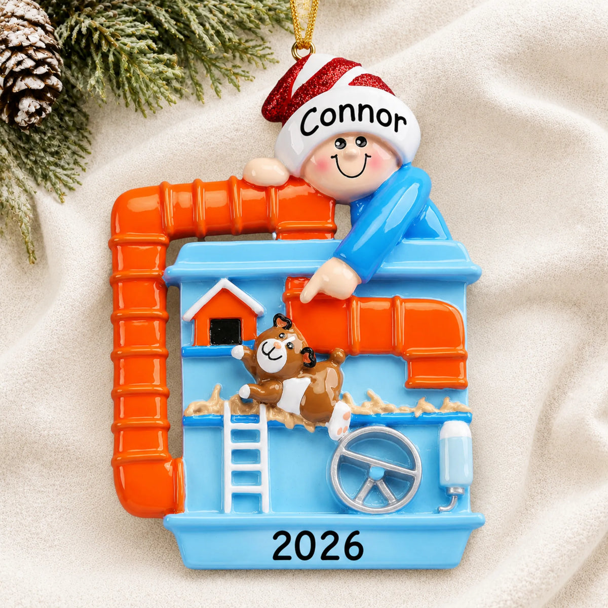 Personalized Hamster & Guinea Pig christmas ornament laid on a soft white knit blanket