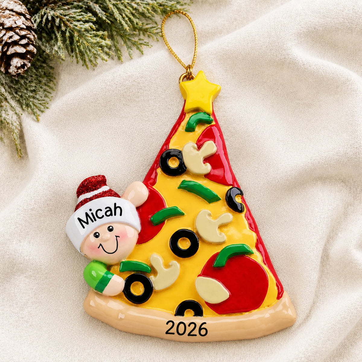 Personalized Pizza Lover christmas ornament laid on a soft white knit blanket