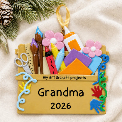 Personalized arts and craft supplies christmas ornament laid on a soft white knit blanket