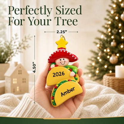 Size guide: the personalized Taco Lover christmas ornament is 2.25 in wide by 4.50 in tall, shown in hand