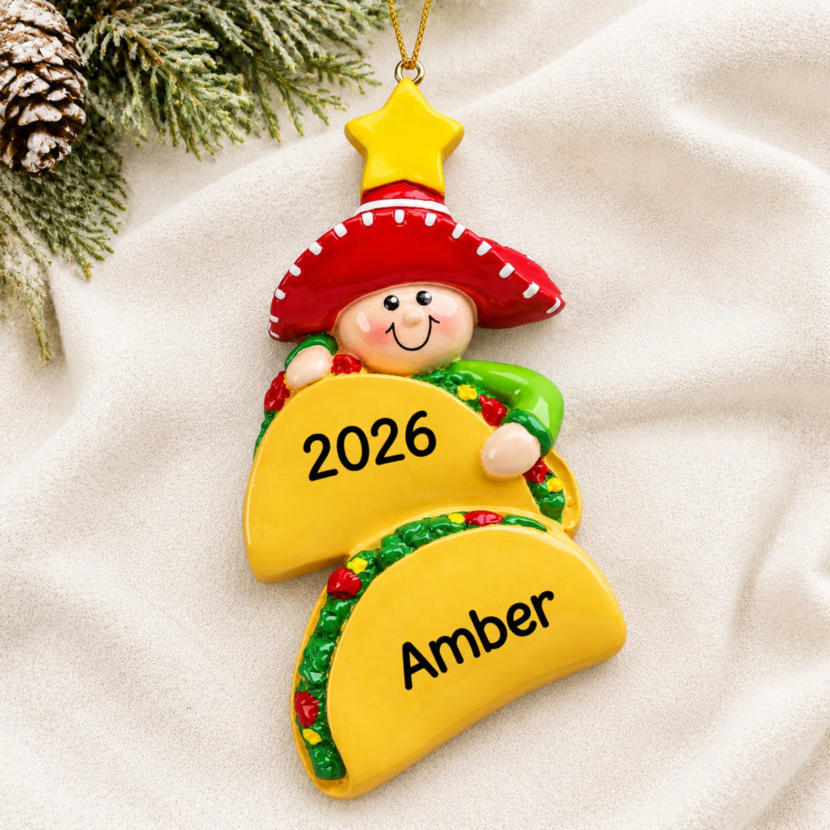 Personalized Taco Lover christmas ornament laid on a soft white knit blanket