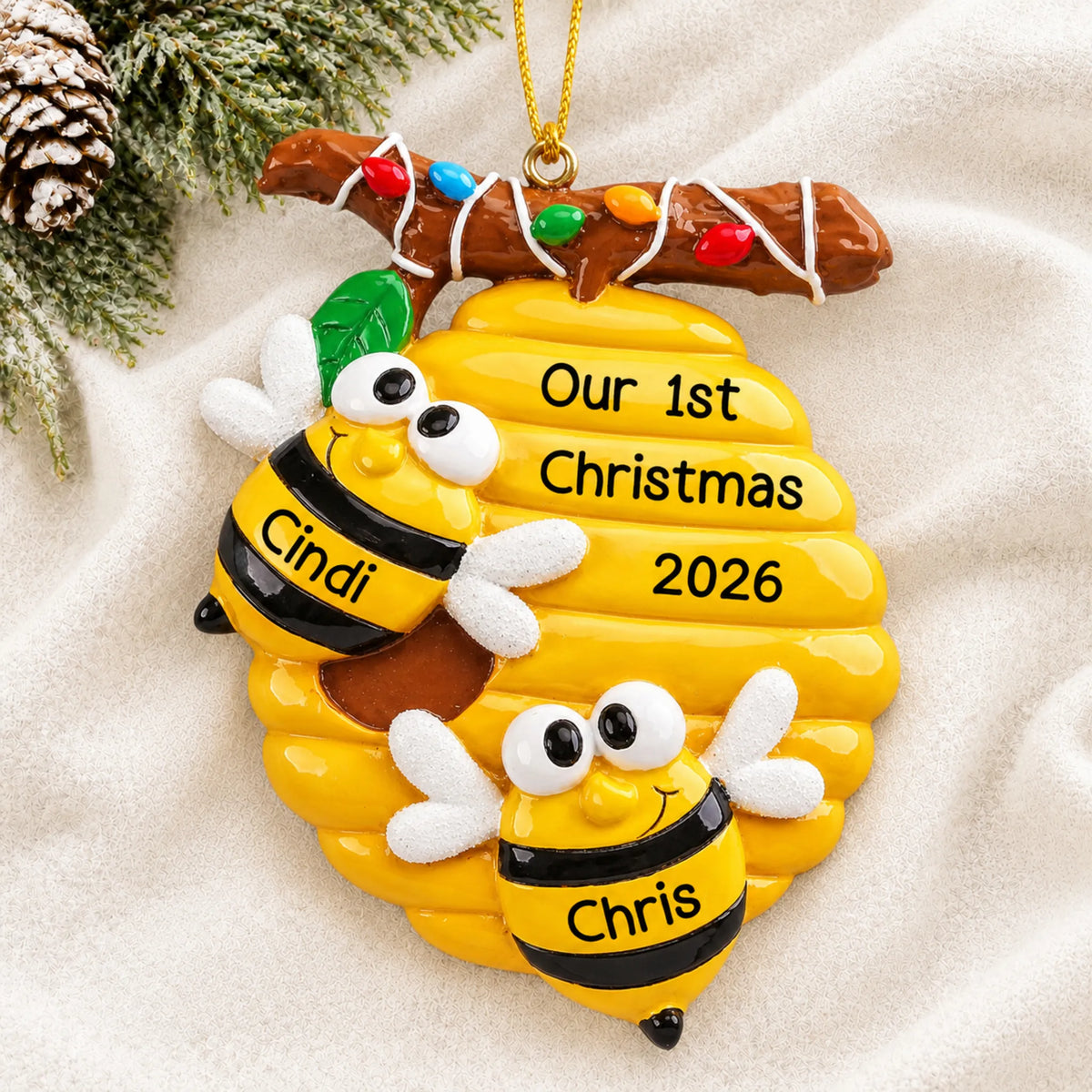 Personalized honey bees couple christmas ornament laid on a soft white knit blanket