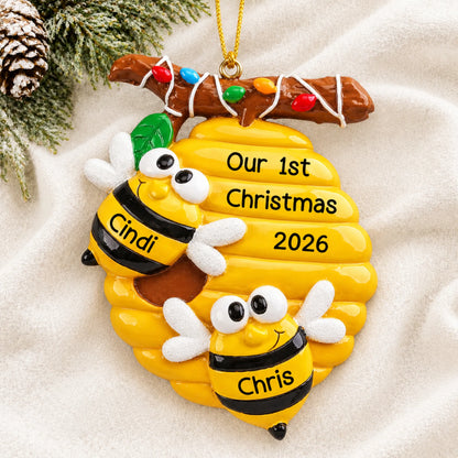 Personalized honey bees couple christmas ornament laid on a soft white knit blanket
