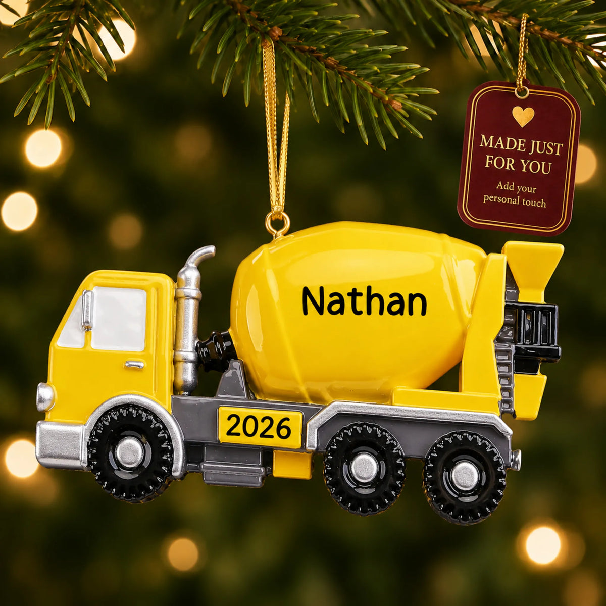 Cement truck christmas ornament hanging on a lit Christmas tree with a Made Just For You gift tag