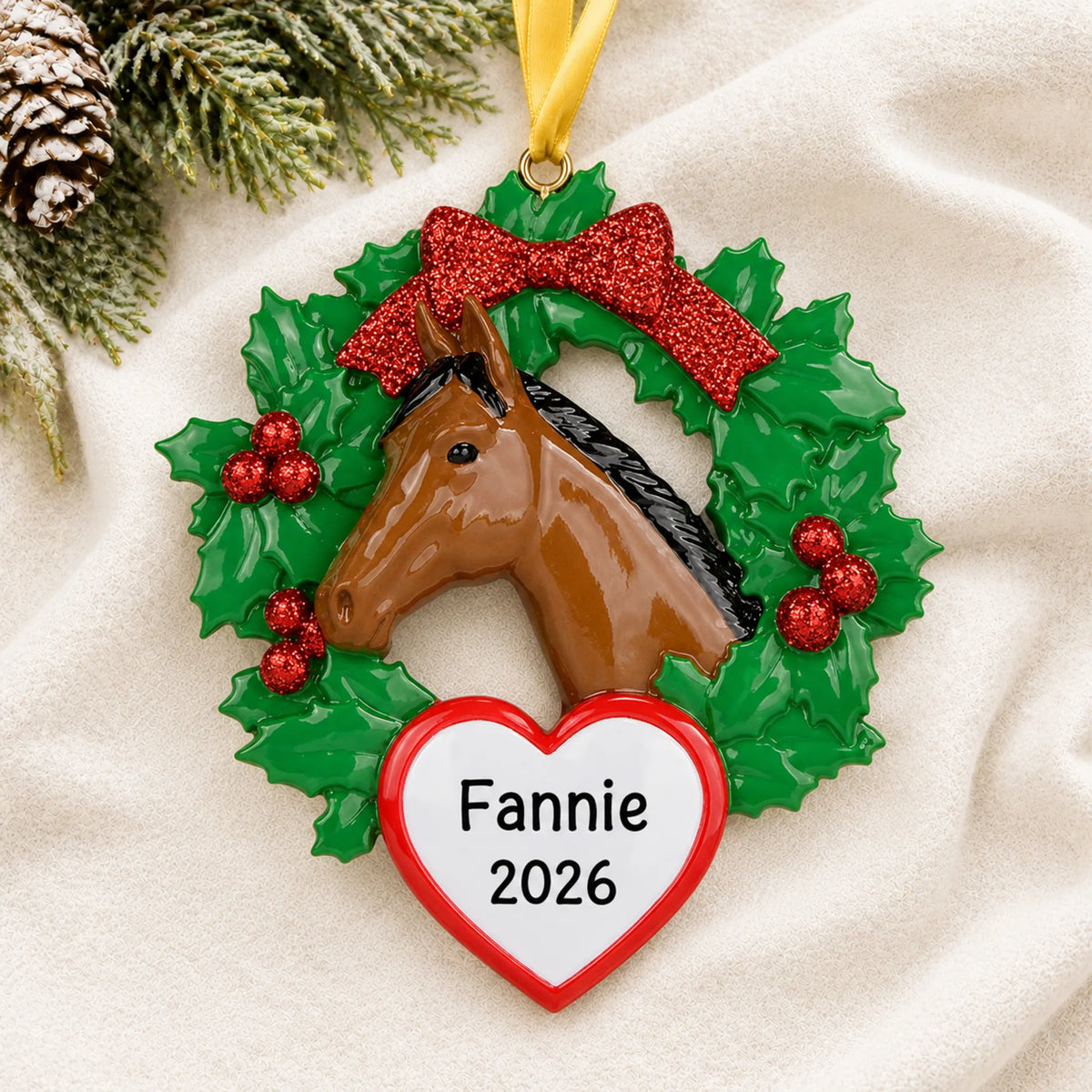 Personalized horse wreath christmas ornament laid on a soft white knit blanket