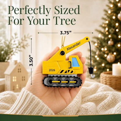 Size guide: the personalized construction crane christmas ornament is 3.75 in wide by 3.50 in tall, shown in hand