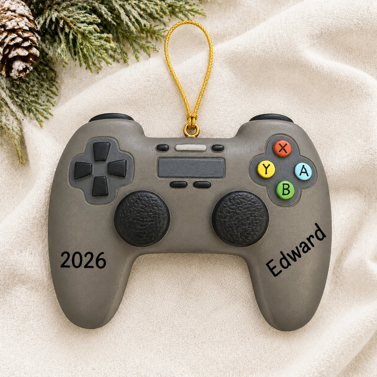 Personalized 3d video game controller christmas ornament laid on a soft white knit blanket