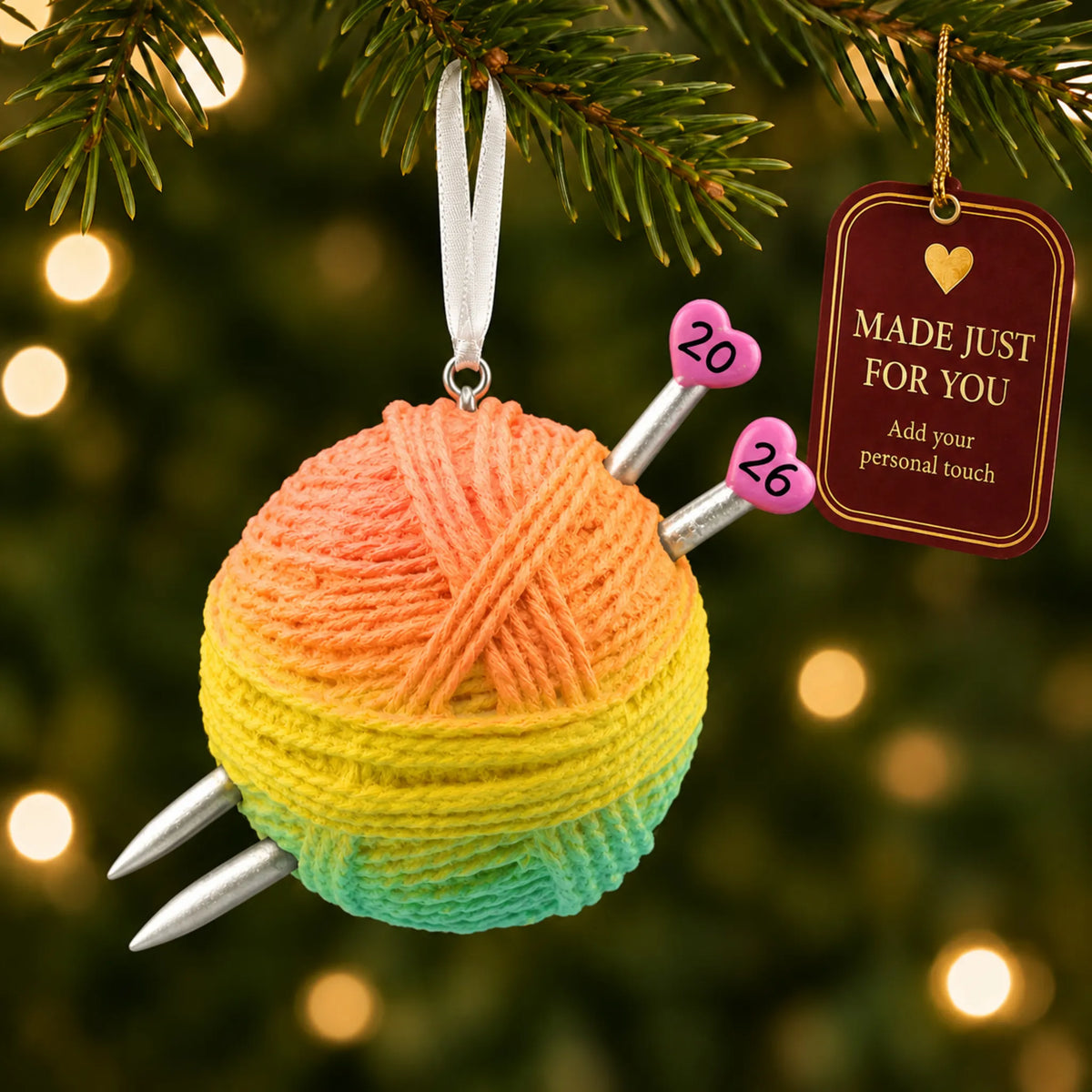 3d knitting yarn ball christmas ornament hanging on a lit Christmas tree with a Made Just For You gift tag