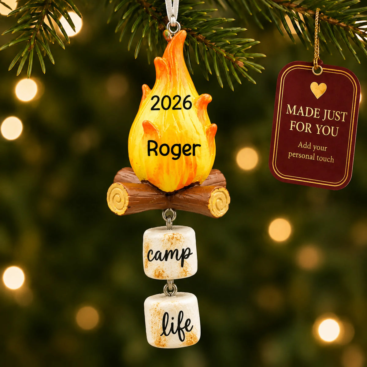 Campfire christmas ornament hanging on a lit Christmas tree with a Made Just For You gift tag