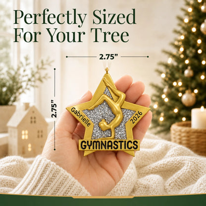 Size guide: the personalized gymnastics gold star christmas ornament is 2.75 in wide by 2.75 in tall, shown in hand