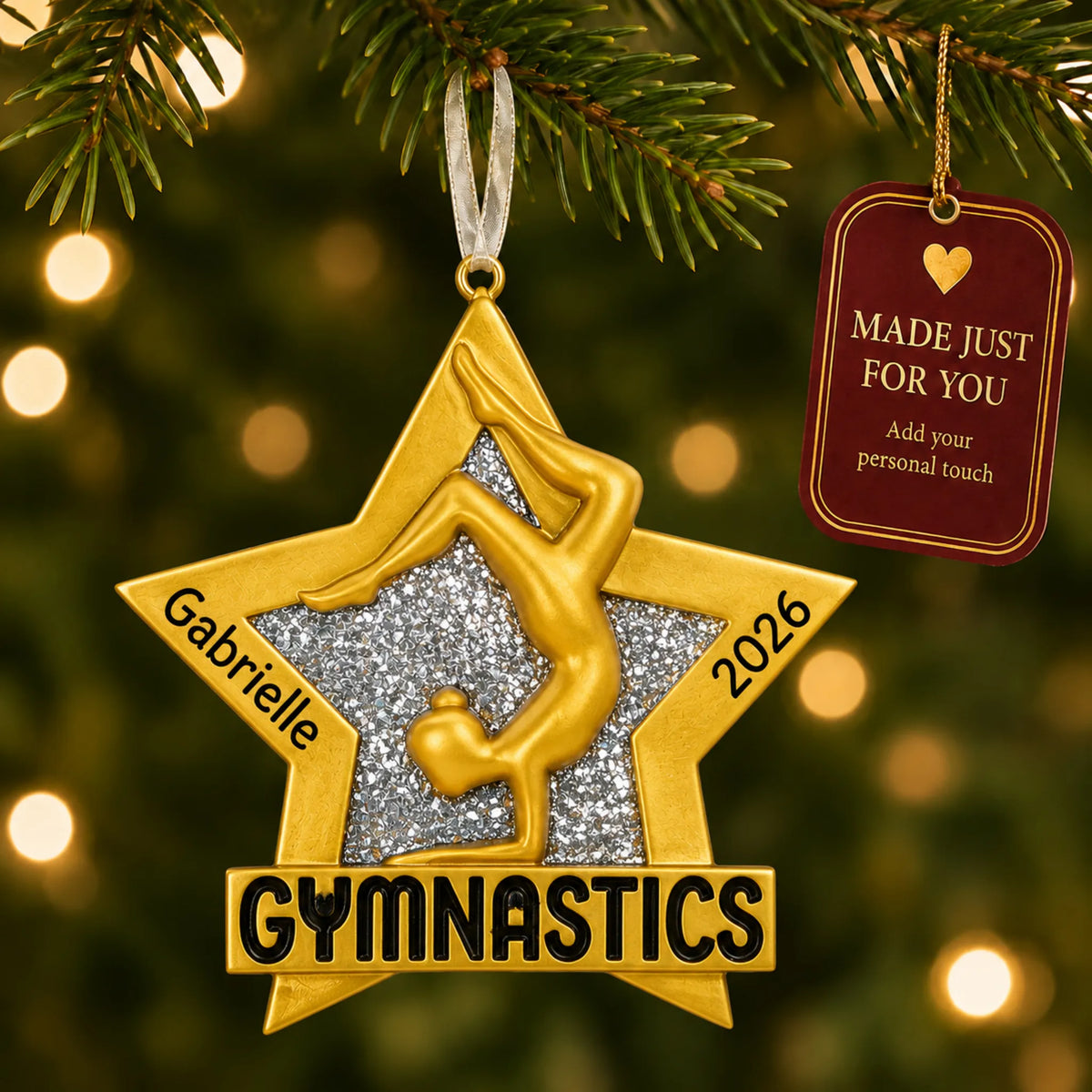 Gymnastics gold star christmas ornament hanging on a lit Christmas tree with a Made Just For You gift tag